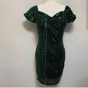 Iris dress black mini dress with  emerald sequins.